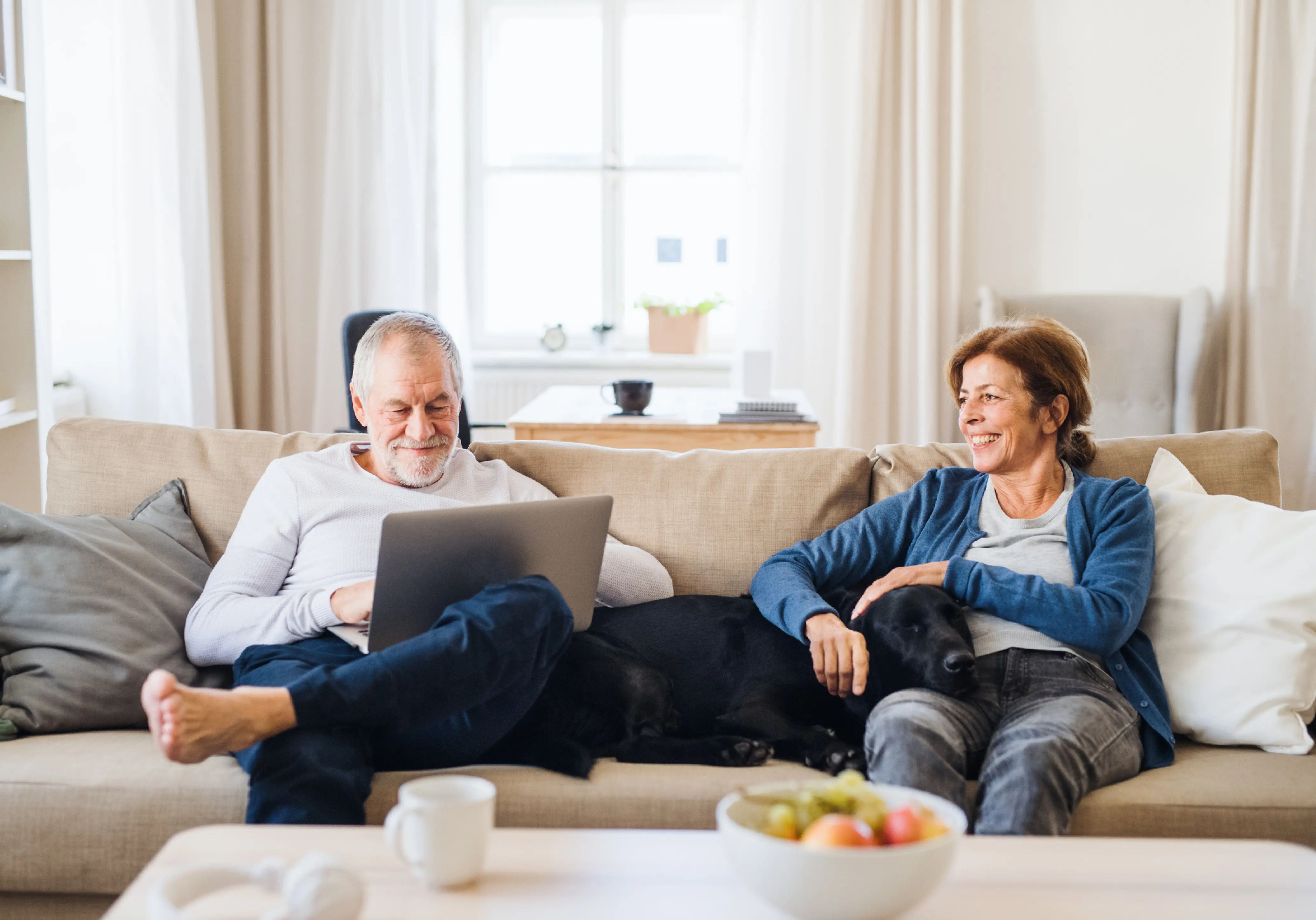 Couple on sofa doing finance