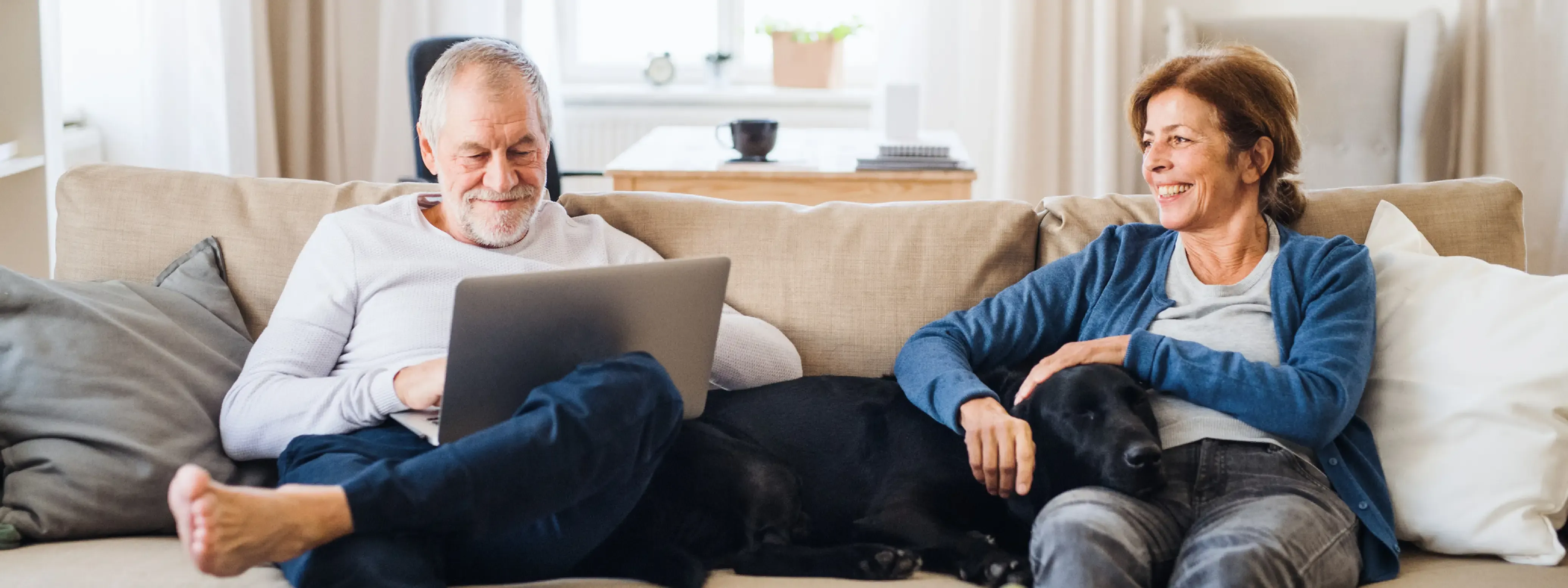 Couple on sofa doing finance